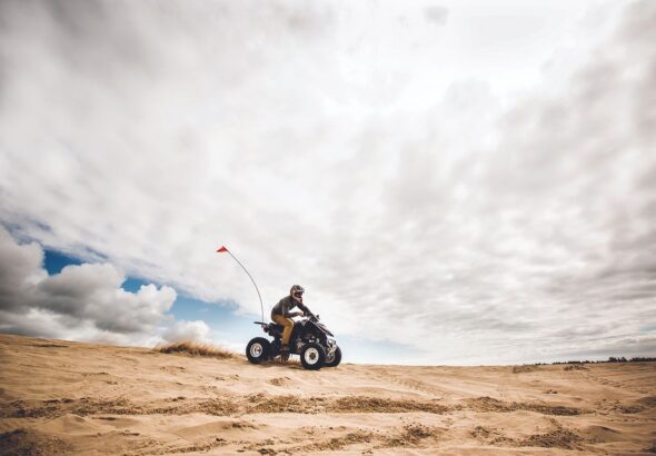 Man riding all-terrain vehicle.