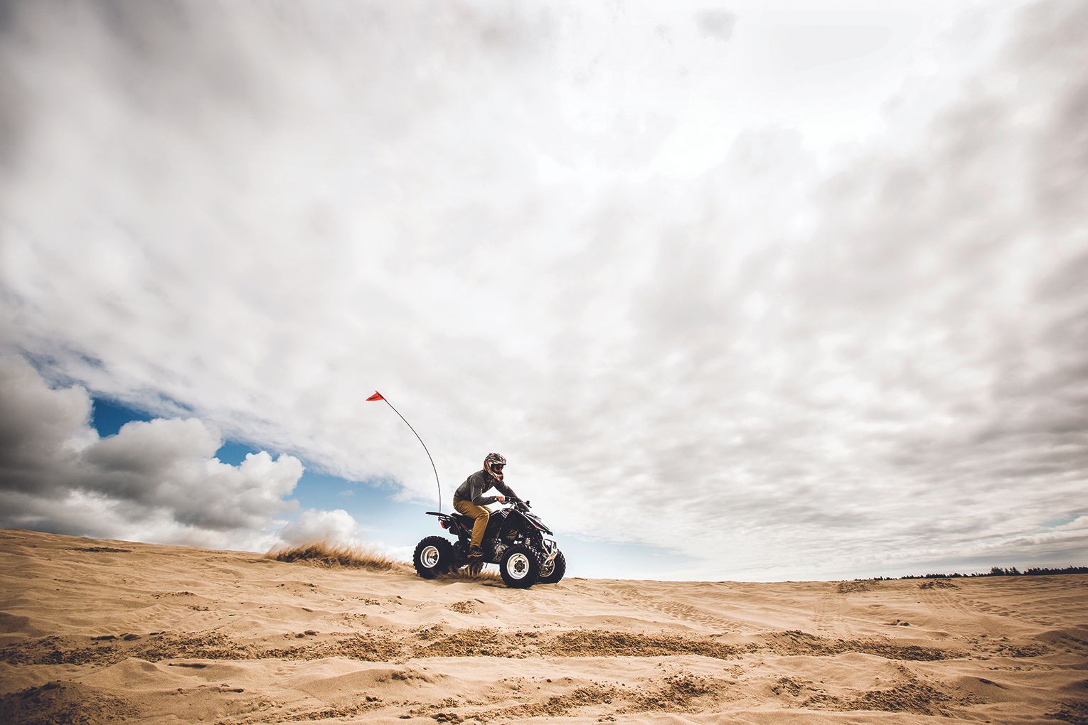 Man riding all-terrain vehicle.